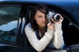 surveillance-female-hanging-out-of-car-with-camera